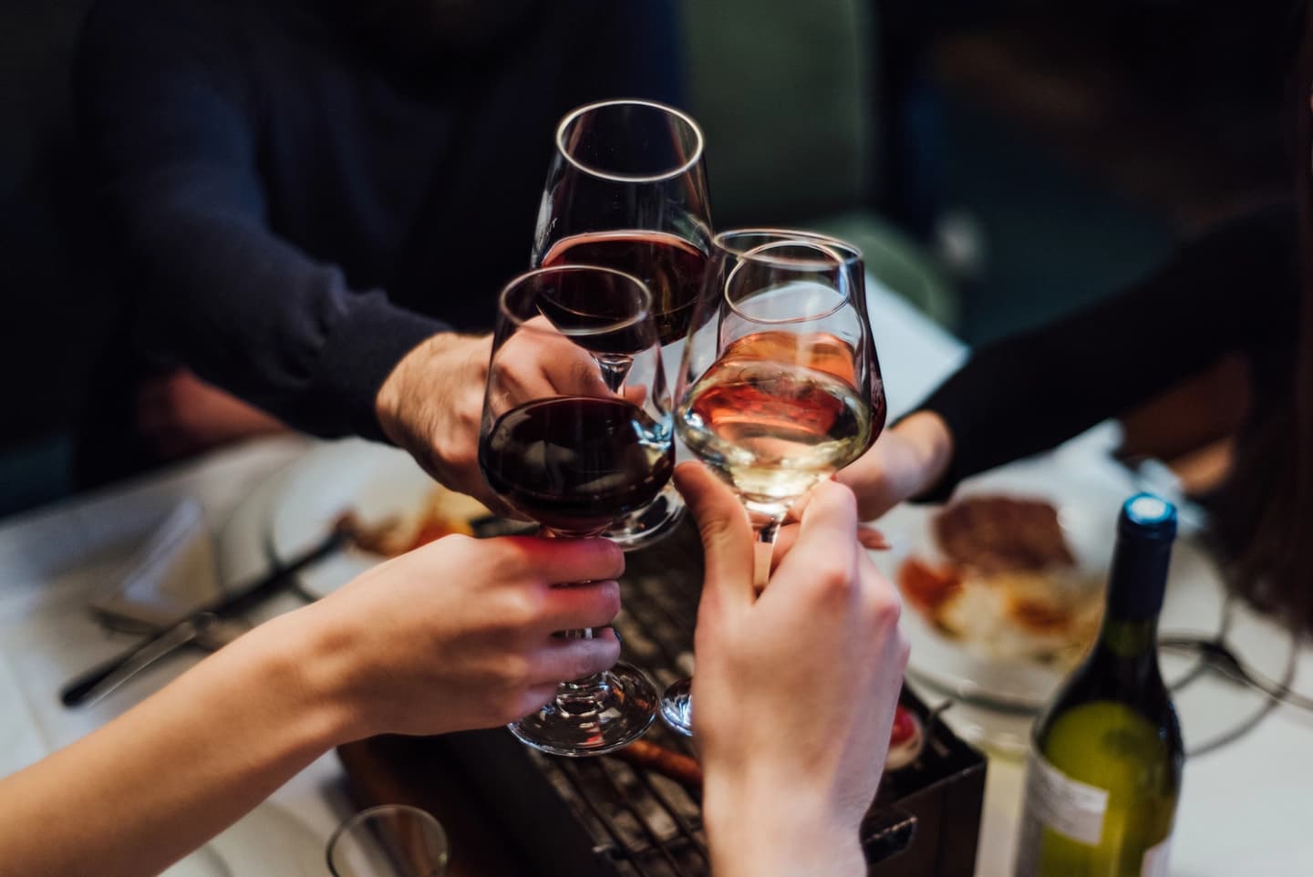 Guests raising their glasses together around a restaurant table